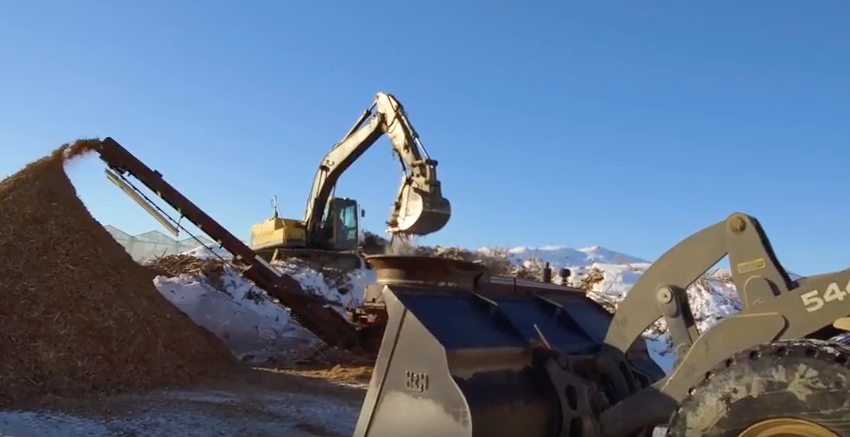 The excavator at NatureFresh moving tons of wood