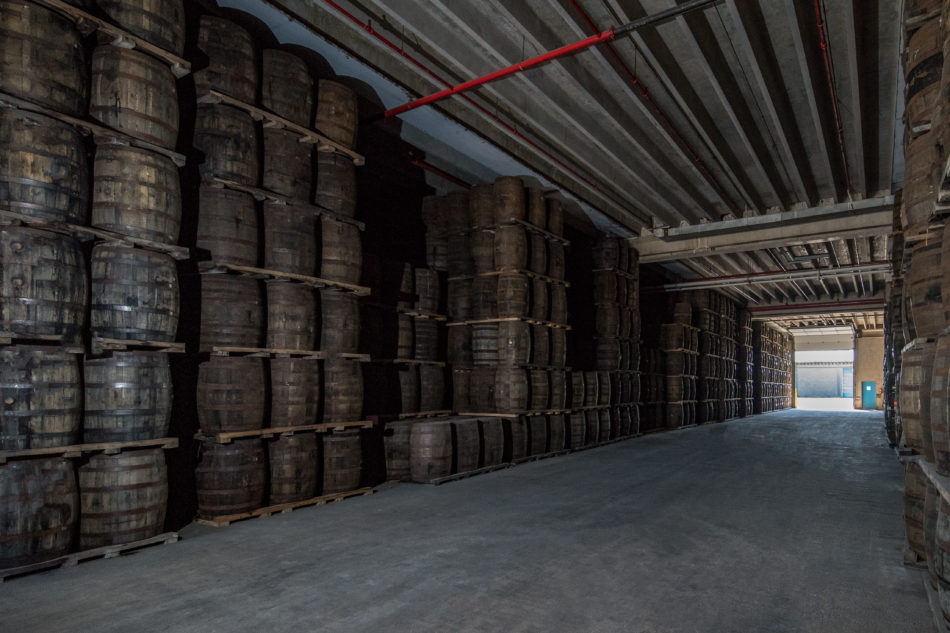 stacks of whisky barrels stored in warehouse
