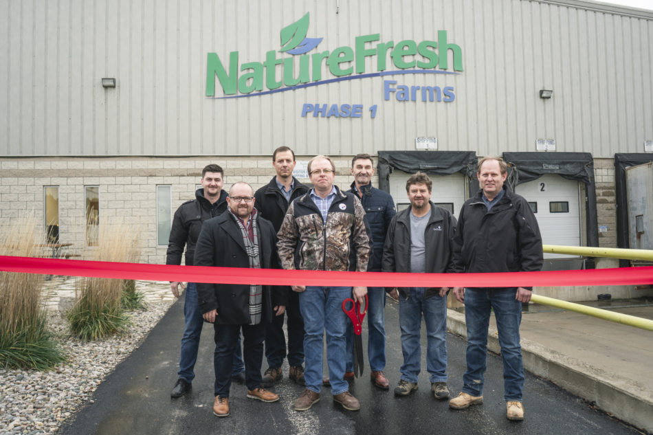Nature Fresh Farms partners standing in front of red ribbon