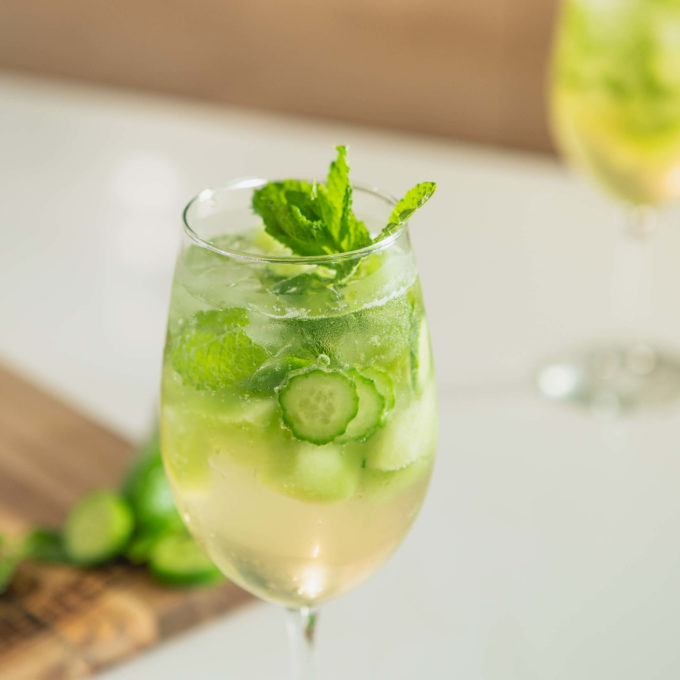 Cucumber Melon Sangria Mocktail served in white wine glass