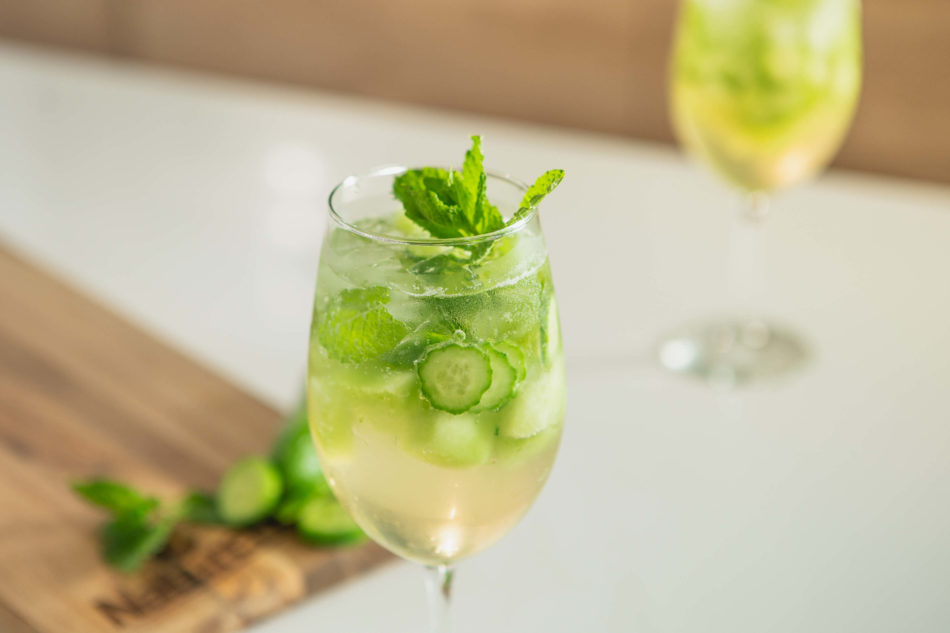 Cucumber Melon Sangria Mocktail served in white wine glass