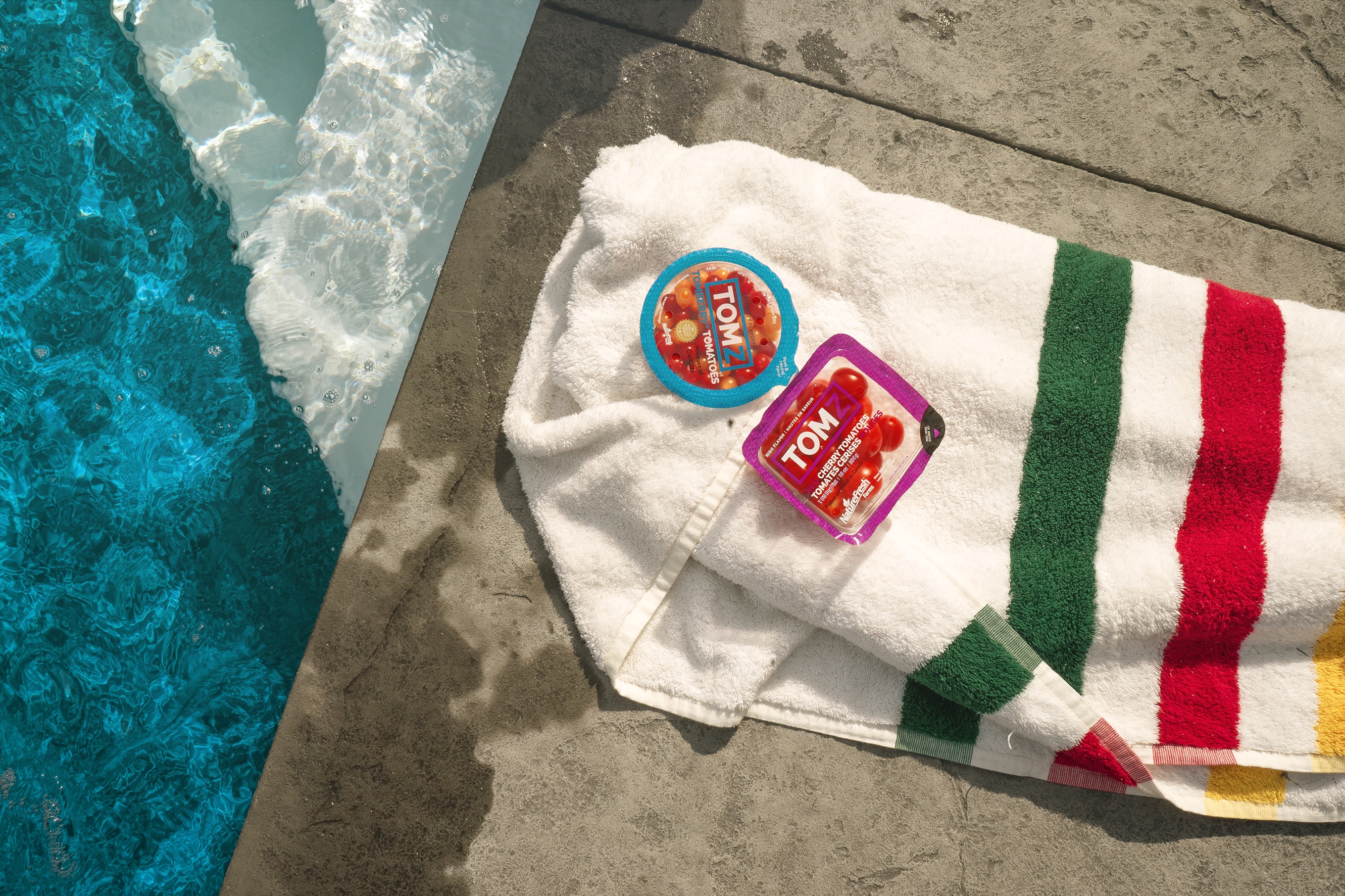 Tomberry Tomatoes on a towel beside a pool