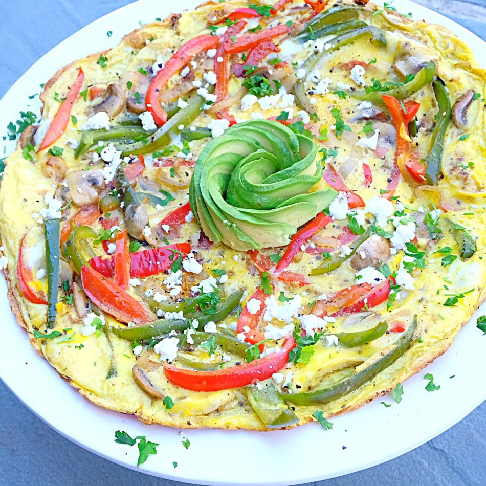 Egg omelet with onions, mushrooms, NatureFresh™ Farms Red and Green Bell Peppers, sheep feta cheese, and fresh parsley